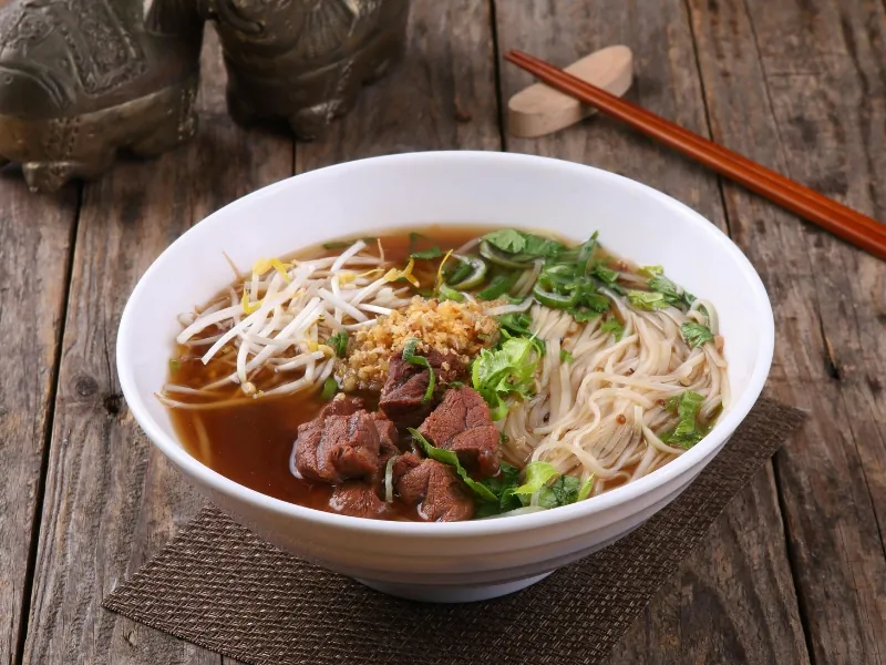 Rich beef brisket pho with garlic and fresh herbs at Pho Highland, a Vietnamese Restaurant in Highland