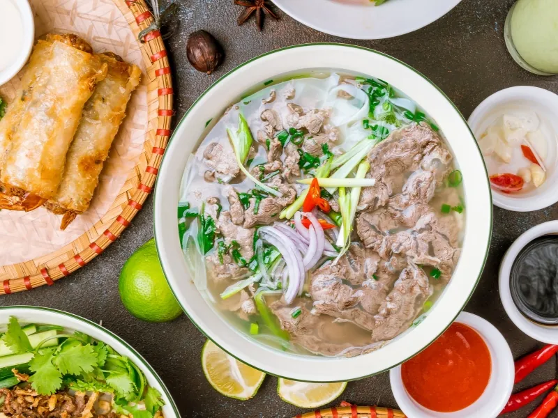 Beef pho set with crispy spring rolls and herbs at Pho Highland, a Vietnamese Restaurant in Highland